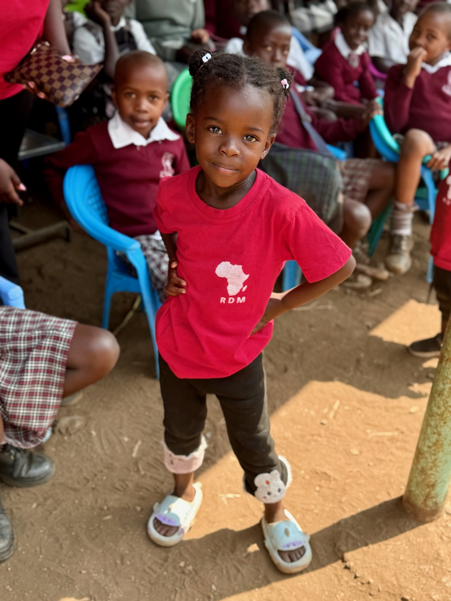 A young child in an RDM shirt at a community gathering