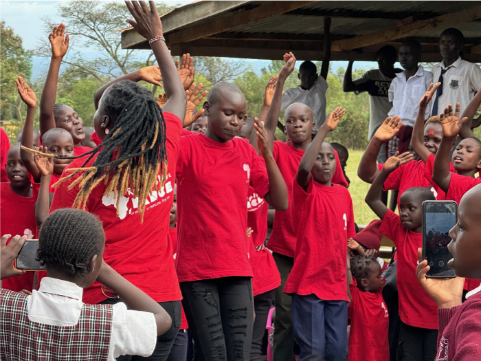 Children in RDM shirts worshipping through movement together