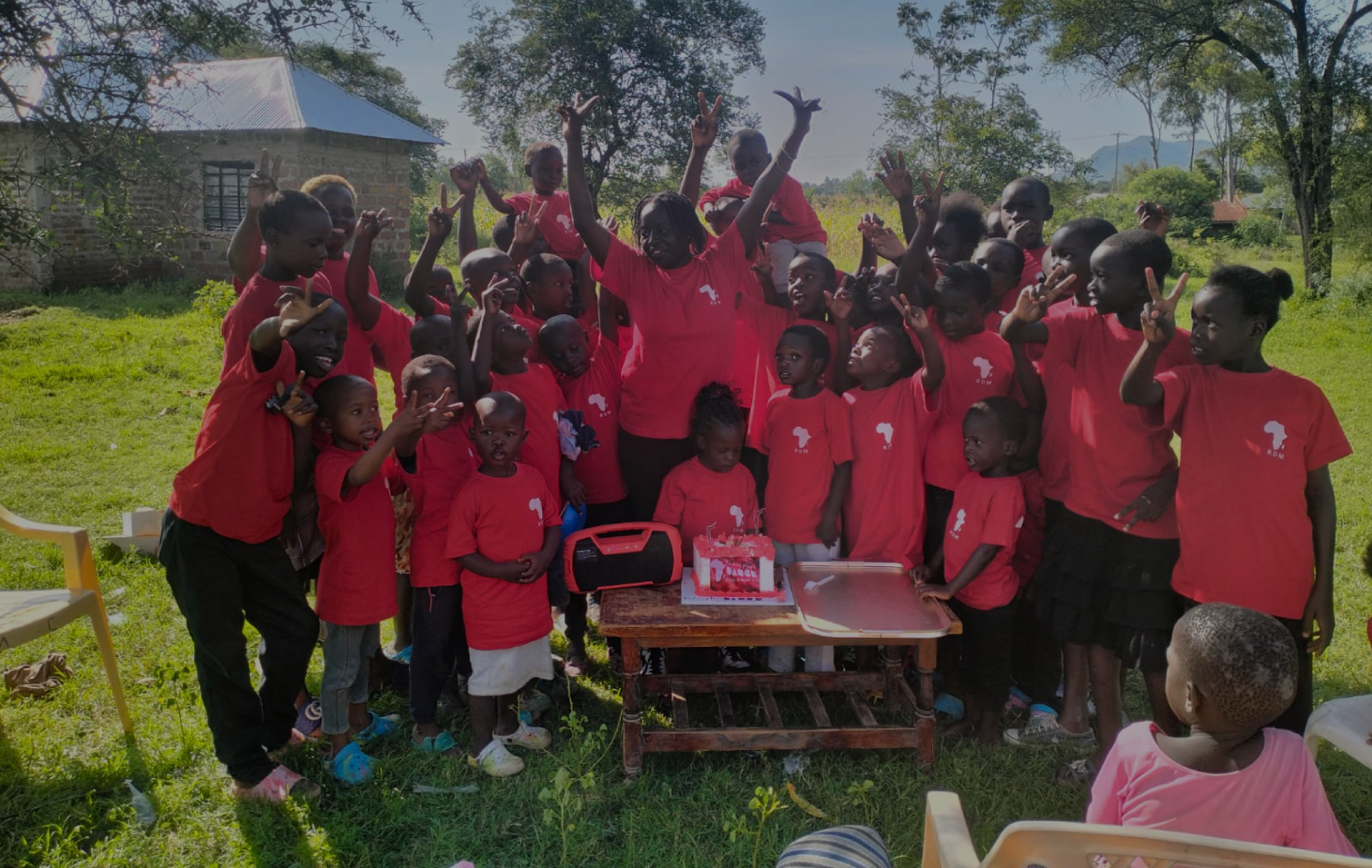 Children in RDM shirts connecting with the mission at a gathering