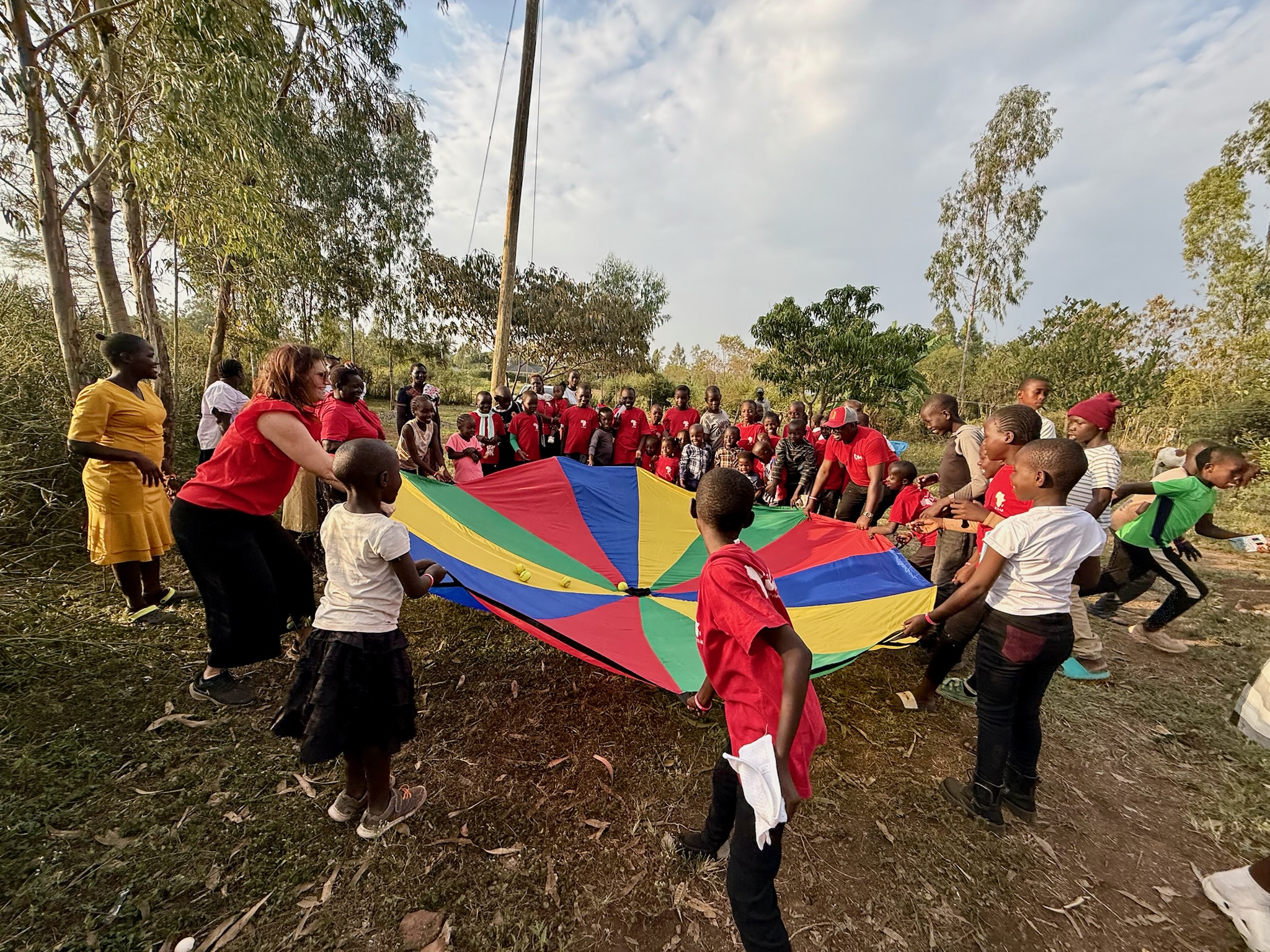 Redemptive Dance Ministries leaders and children playing together in Kenya