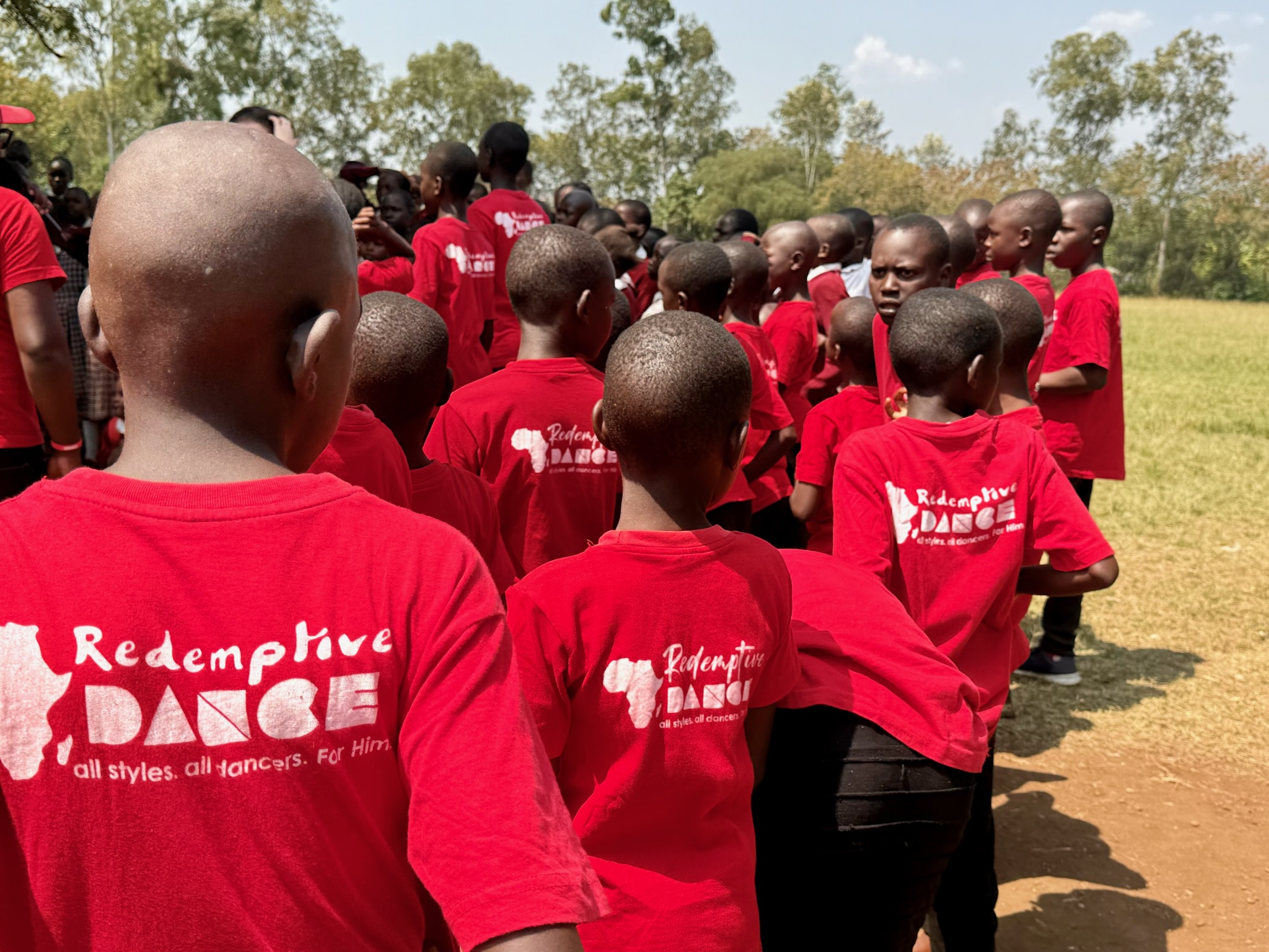 Young dancers in Redemptive Dance Ministries shirts gathered together