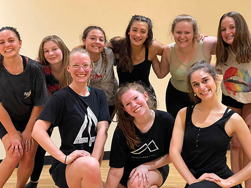 Group of joyful dancers smiling after a dance class in a studio