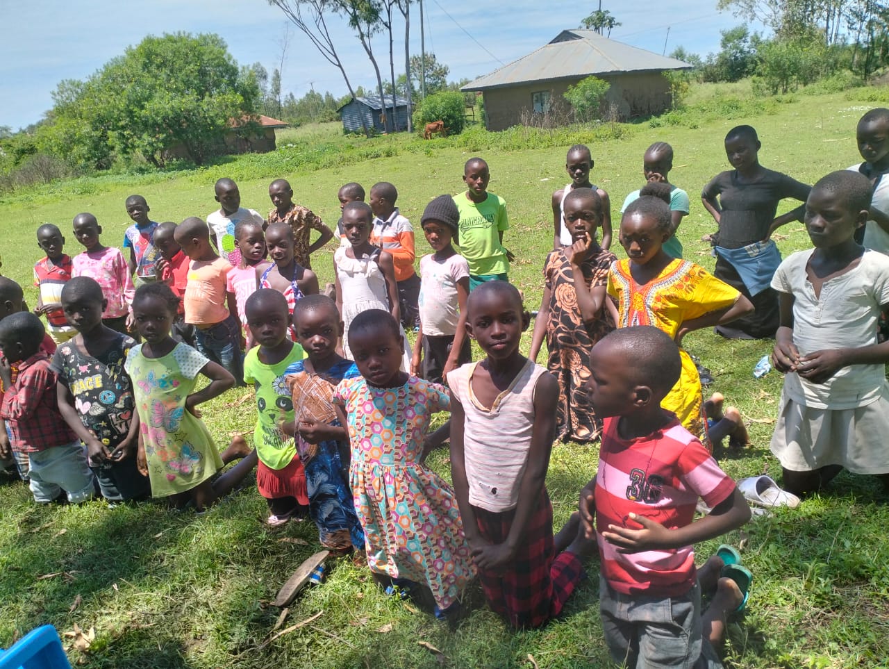 Group of Kenyan children from RDM.life's dance program gathered outdoors, showcasing the community's vibrant spirit and unity.